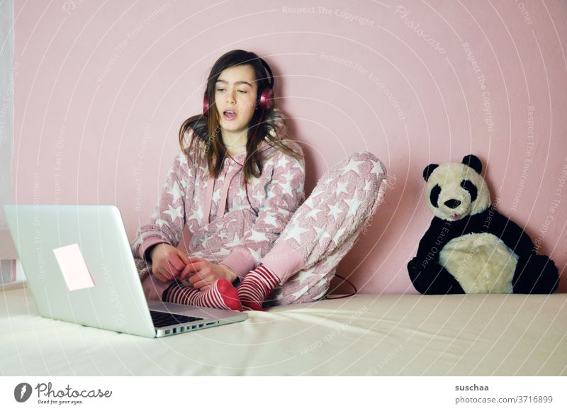 teenagers sit in front of their laptops and listen to music or chat with friends. the panda stuffed animal is also there ... youthful Youth (Young adults) Child