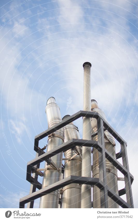 Metal pipes for exhaust and ventilation on a ferry protrude into the slightly cloudy blue sky reeds Exhaust gas Glittering Ferry Above Upward White Gray ship