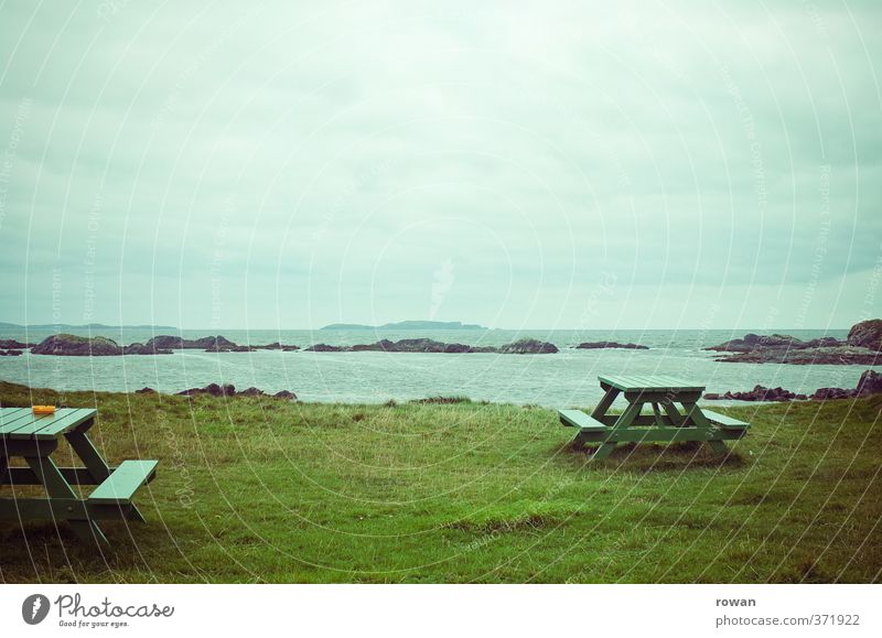 picnic Beautiful weather Grass Break Ocean Beach Coast Picnic Table Vantage point Ireland Green Relaxation Empty Loneliness Cold Gloomy Ashtray Clouds