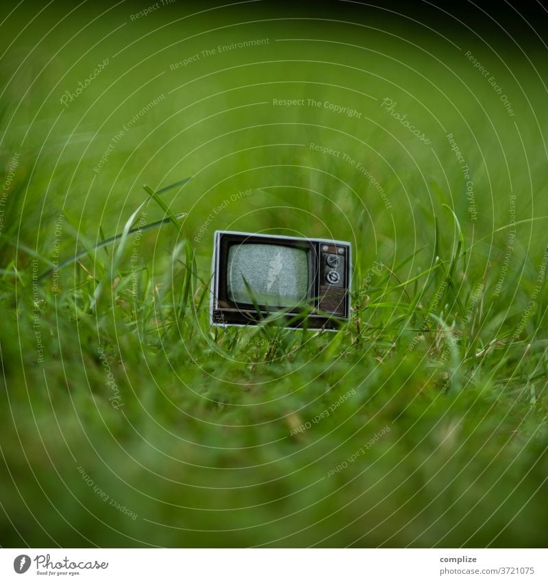 imgrünen.tv TV set vintage Bulk rubbish Trash waste Broken 70s 80s chuck away Old Television, television screen technology Program Grass green Meadow Garden cut