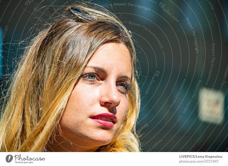 Portrait of a pretty young lady with blond hair and green eyes background close-up copy space dame day daylight front view looking away outdoors people portrait