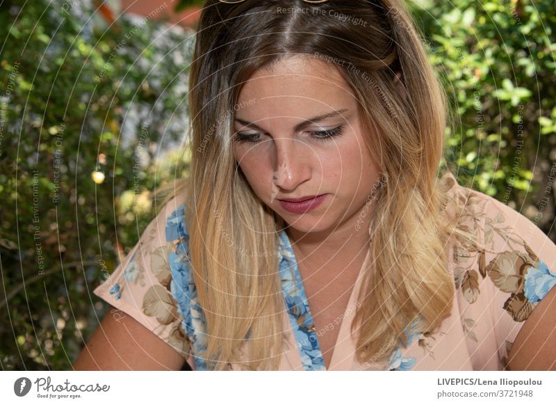 Close up of a young woman with blond hair looking away background close-up copy space dame day daylight eyes face front view head lady outdoors people portrait