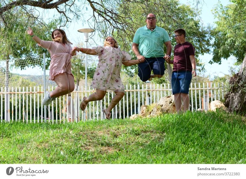 happy family Family jumps in the air Happy family family vacation Mother Father Daughter Son Crazy Family Vacation photo