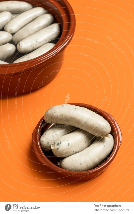 German white sausage in ceramic bowl. Bavarian veal sausage. Traditional food Germany Oktoberfest background bavarian boiled breakfast brown ceramic pot cooked