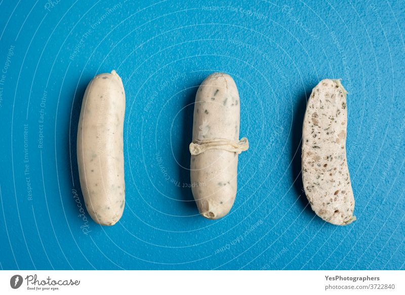 German white sausage table top view. Bavarian veal sausage section Germany Oktoberfest aligned background bavarian blue boiled breakfast close-up cooked cooking