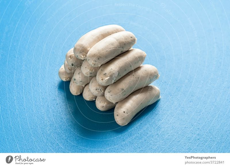 German white sausages stacked in a pile. Bavarian veal sausages. Cooked weisswurst Germany Oktoberfest aligned background bavarian blue boiled breakfast bunch