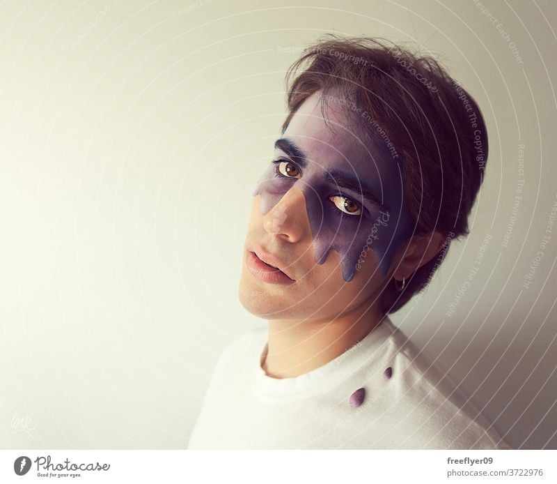 Portrait of a man with a purple substance dripping out of his face illness infection fever copy space coronavirus covid 19 portrait young blank background