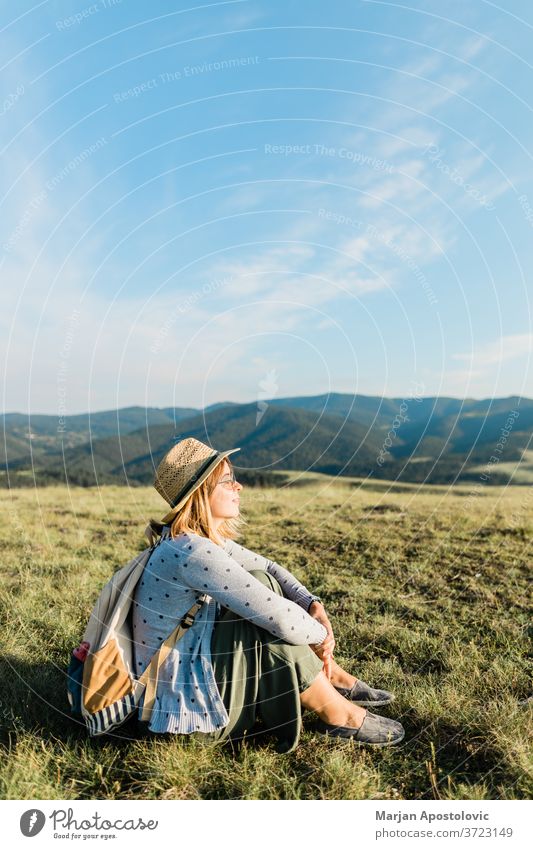 Young female nature lover enjoying the sunset in the mountains adventure alone backpack backpacker bag beautiful casual discovery environment explore freedom