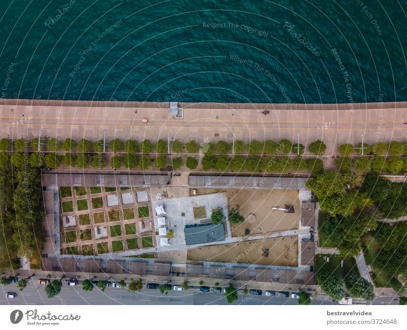 Thessaloniki, Greece aerial drone landscape view of renovated waterfront with bikeway. Day top panorama of European city with greenery & pedestrian area promenade before a calm seafront.