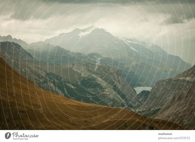 alpine panorama Environment Nature Landscape Elements Sky Clouds Storm clouds Bad weather Rain Rock Alps Mountain Peak Threat Blue Brown Gray Loneliness Respect