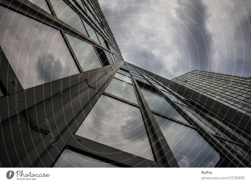 Reflection of thunderclouds in a glass facade. Facade High-rise office Office complex reflection Economy real estate technique Architecture Moody Sky