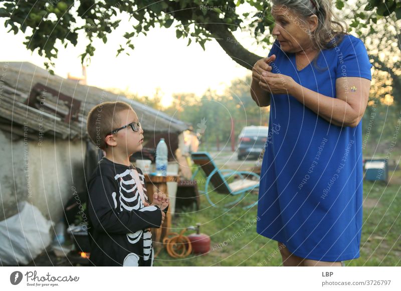 Woman speaking to child wearing a skeleton costume Portrait photograph Love Truth Trust Emotions Life Infancy Couple Family & Relations Grandmother