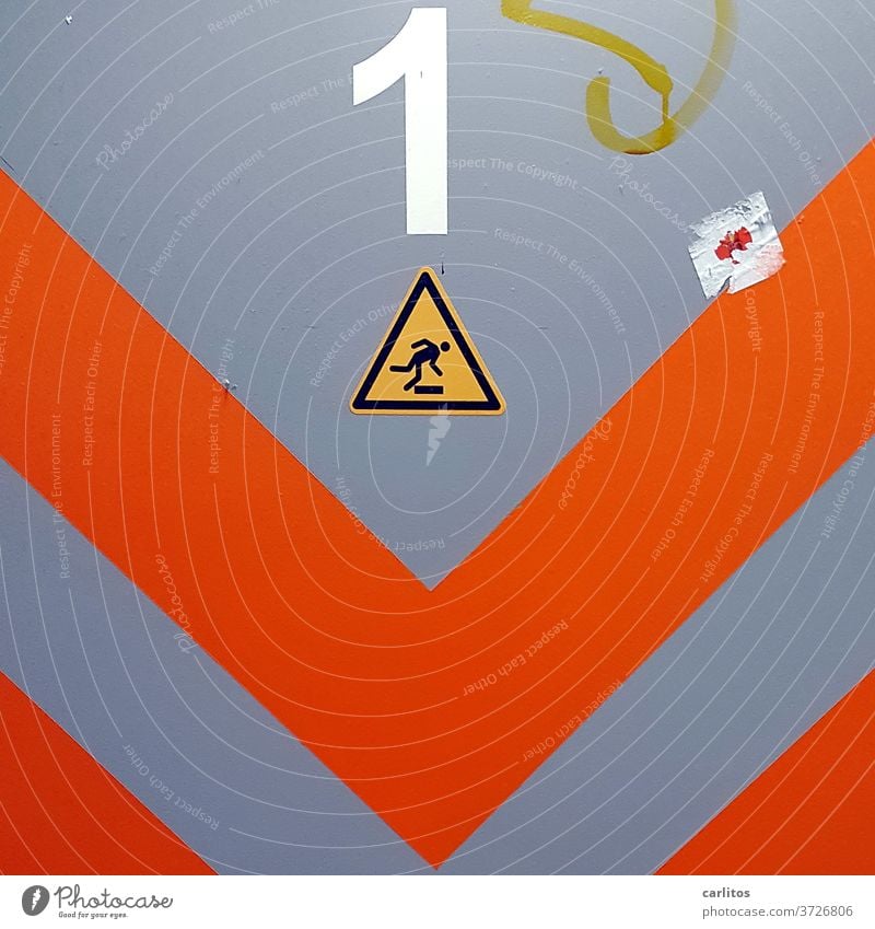 Red angles, black-yellow sign on grey door: 1 | Stumble once, fall once, get up once ! Gray Warn Warning sign Black Yellow Triangle trip hazard To fall one