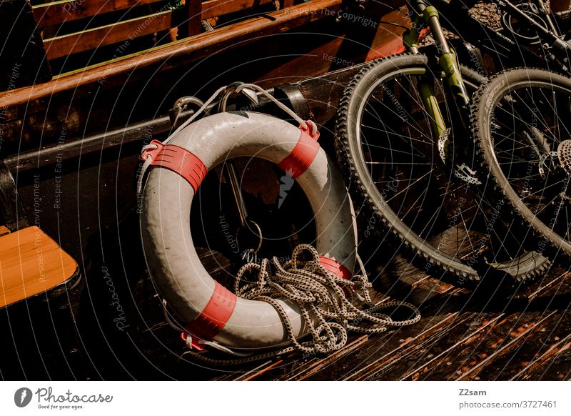 Lifebelt on a ship Danube Danube breakthrough Crossing Bicycle boat shipping wooden floor rescue tyre Life belt Mountain bike Wheel Summer Sun River Bavaria