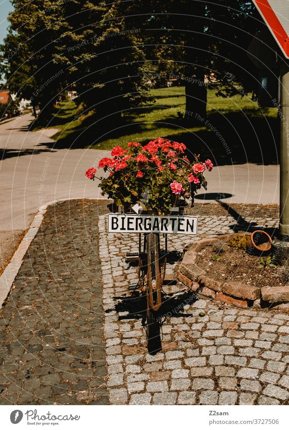 Beer garden hint Gastronomy Summer Sun flowers Flowerpot Bicycle Clue customer stopper Rural Green Nature Village Street refuge sign Culinary Exterior shot