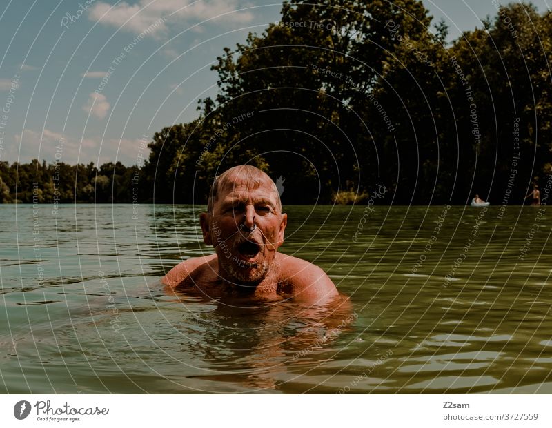 Pensioners swimming in the lake be afloat free time annuity Summer Lake Body of water Water Sports Movement nose clip Athletic Brown age Man portrait