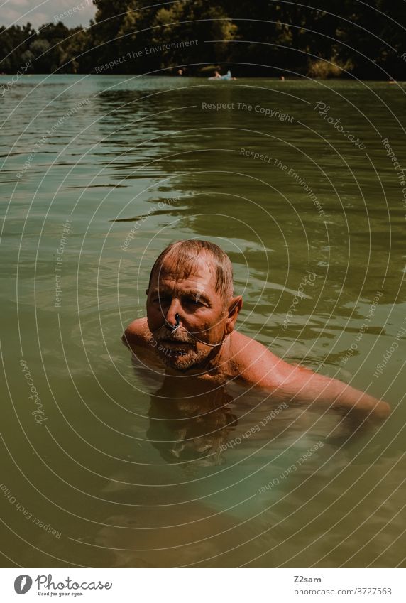 Pensioners swimming in the lake be afloat free time annuity Summer Lake Body of water Water Sports Movement nose clip Athletic Brown age Man portrait