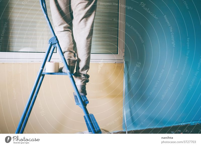 Man working in a room renovation reform home job house paint man male home improvement move removal relocation hard work work at home leisure active stairs