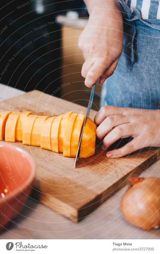 Butternut pumpkin being cut with chef's knife butternut pumpkin Pumpkin Food Food photograph food styling Food And Drink Vegan diet Vegan Food veganism cuisine