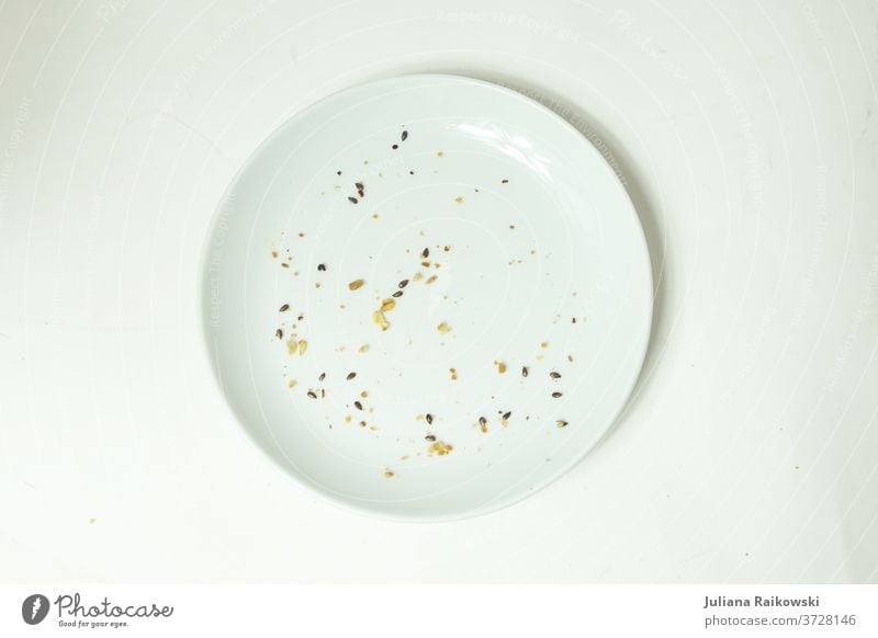 Empty plate with crumbs Plate Crockery White Nutrition Appetite Food Deserted Lunch Neutral Background Delicious world hunger Crumbs Eaten Pottery Interior shot