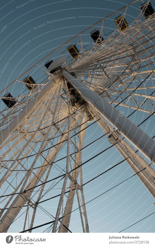 Ferris wheel in Munich from below Fairs & Carnivals Leisure and hobbies Sky Tall Joy Rotate Round Exterior shot Blue Colour photo Theme-park rides Carousel Day