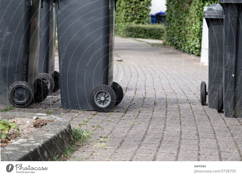 The garbage can path - black garbage cans standing on the sidewalk Waste bins off Sidewalk Trash Trash container Waste management Refuse disposal Environment