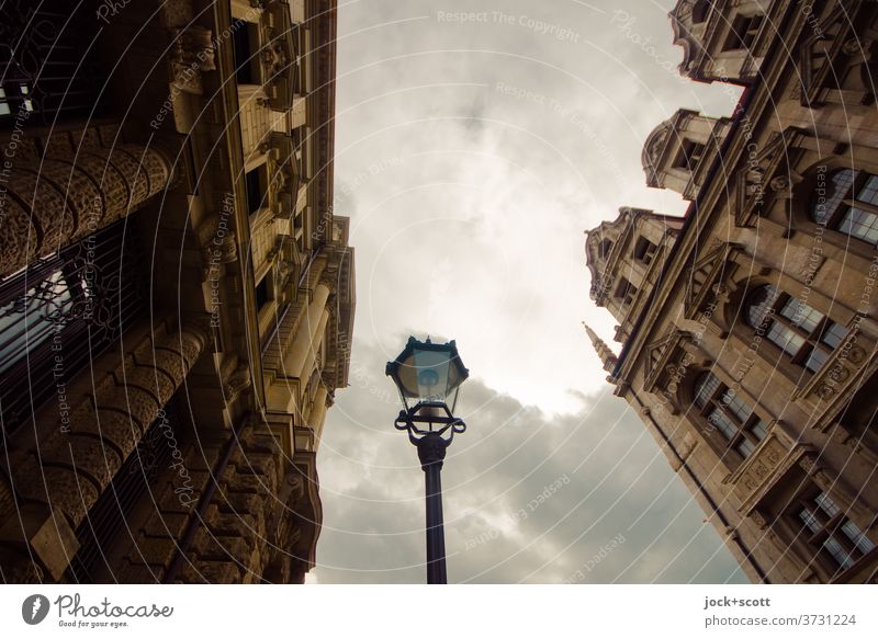 Historic lantern between old facades Facade Past Clouds Historicism Tourist Attraction Moody Original Tradition Ornate Twilight Architecture Downtown