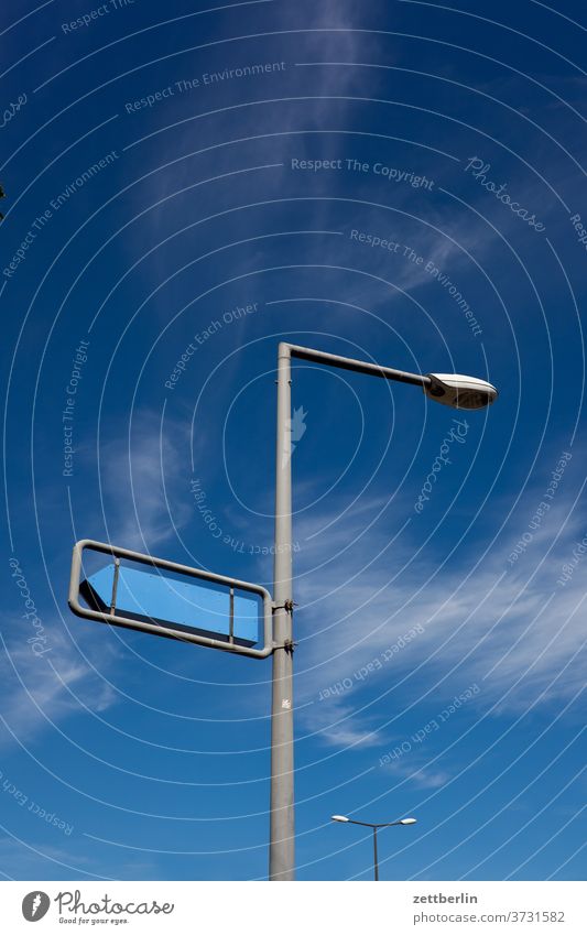 Signpost with two lanterns Lantern streetlamp Lamp light Road marking sign Clue Signage Direction Arrow Orientation Sky Clouds Weather Navigation Right Left