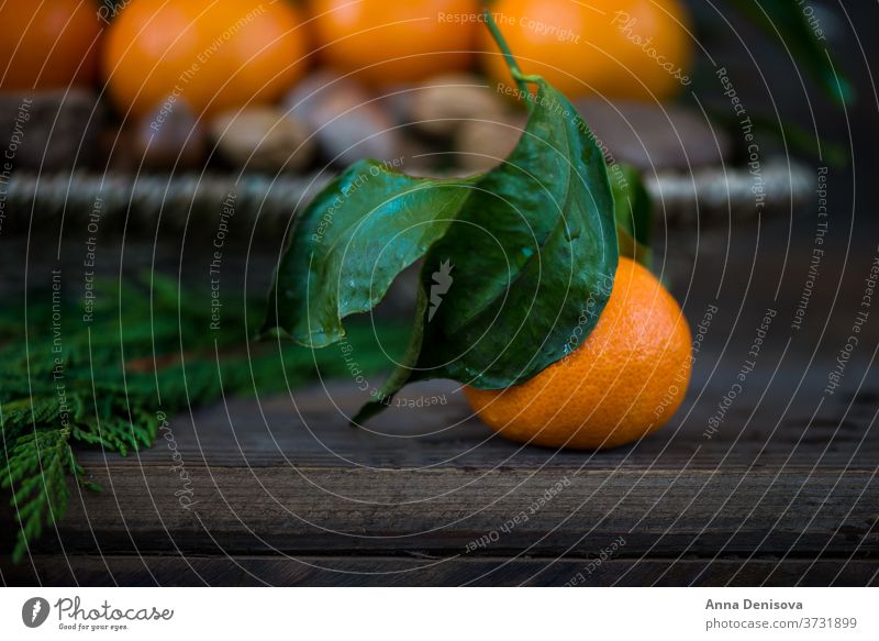 Nuts, Fresh Clementines or Tangerines in the Basket and Xmas Tree Branches on Brown Wooden Background 2017 2018 postcard tangerine abstract background basket