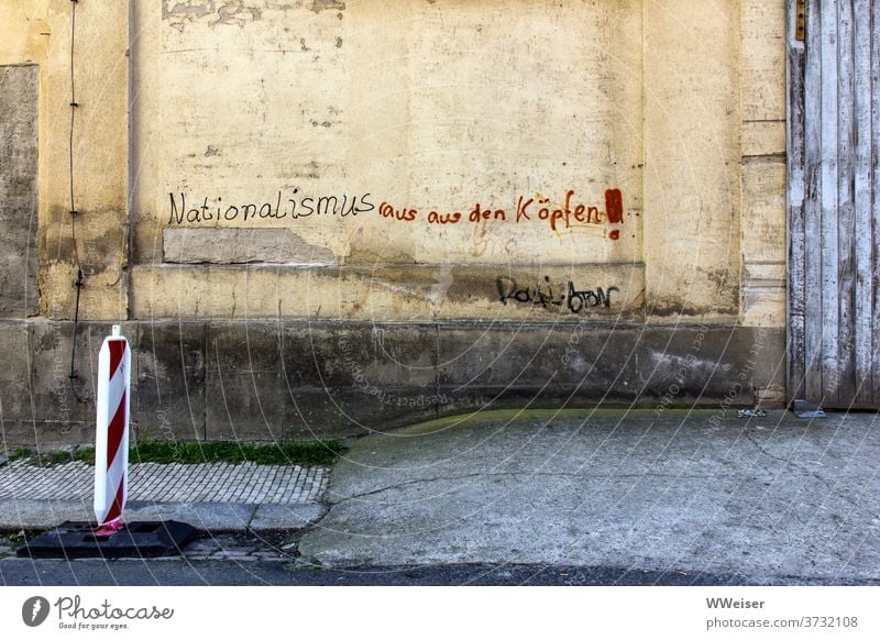 Nationalism out of your head! - demands the old house wall Wall (building) Wall (barrier) writing Slogan nationalism nazis out rights Nazis antifa Small Town