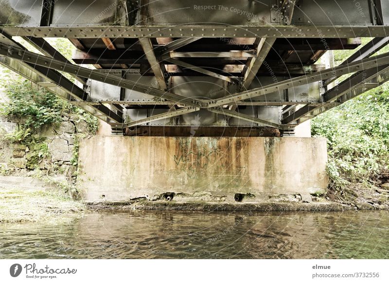 View of the underside of a small steel bridge that spans a river Steel bridge Metal Railway bridge River Bridge pier Bridge construction Rivet Water bottom