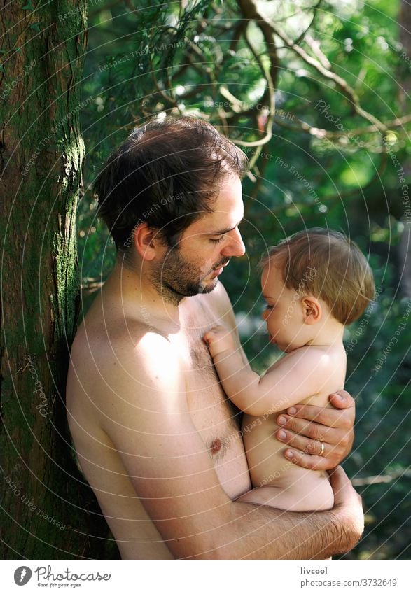 dad with baby in the garden kid child boy having fun happy smile father enjoy tree nature outdoor blue eyes tender people portrait lifestyle family one people