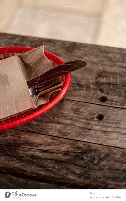 A basket with cutlery and napkin on a wooden table in a restaurant Restaurant Cutlery Set meal Basket Eating Gastronomy eat out Rustic Guesthouse Red Table Meal