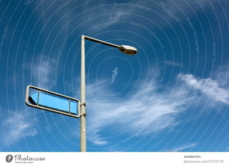 Signpost with lantern Lantern streetlamp Lamp light Road marking sign Clue Signage Direction Arrow Orientation Sky Clouds Weather Navigation Right Left