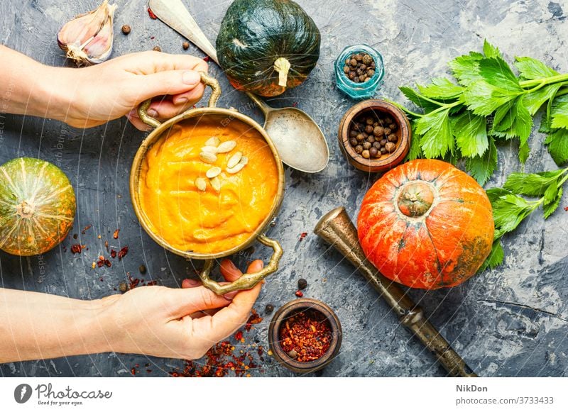 Pumpkin vegan soup pumpkin hands bowler autumn food vegetable cream healthy squash vegetarian creamy halloween rustic traditional diet eating herb fall puree