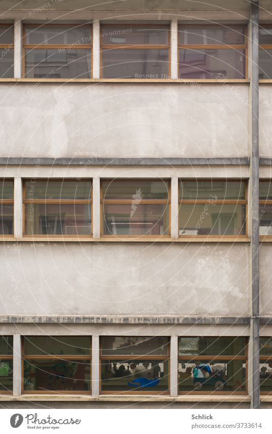 Dull facade of a kindergarten in Lorraine Kindergarten Facade Gray Gloomy Children's drawing Window squares downspout bearded Beach ball Cat pictures Painted