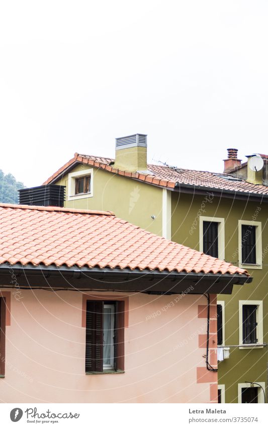 colorful houses in the north of spain pink house pink wall green house green wall window Town house (City: Block of flats) roof rooftops Spain pais vasco