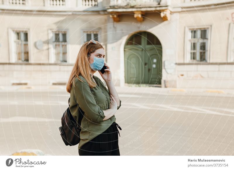 Young woman with mask talking on the phone outside in the city 2020 adult beautiful blue caffè caucasian child childhood concept coronavirus covid-19