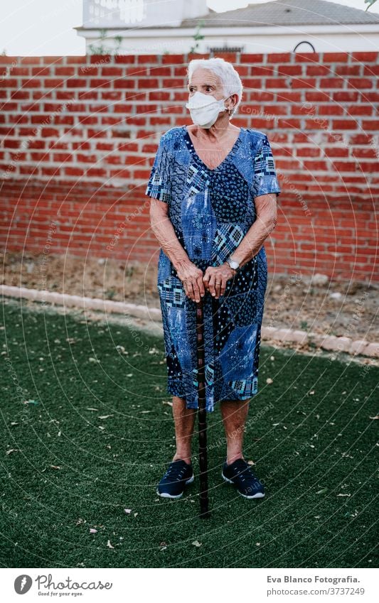 portrait of old lady wearing protective mask. new normal corona virus elder 80s grandmother woman elderly home white hair grey hair mental aged health care