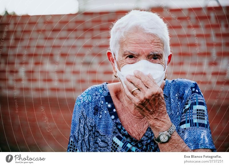 portrait of old lady wearing protective mask. new normal corona virus elder 80s grandmother woman elderly home white hair grey hair mental aged health care