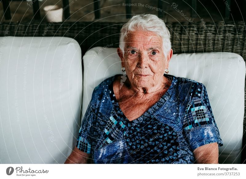 portrait of old lady in her 80s relaxed at home. woman elderly garrotte white hair grey hair mental solitude thoughtful grandmother aged health care looking