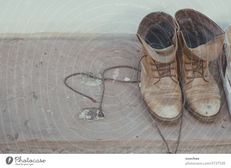 old shoes standing on a windowsill to take away Footwear lace-up shoes Old Second-hand second hand to give away shoelaces Laced boot Brown tones Windowsill