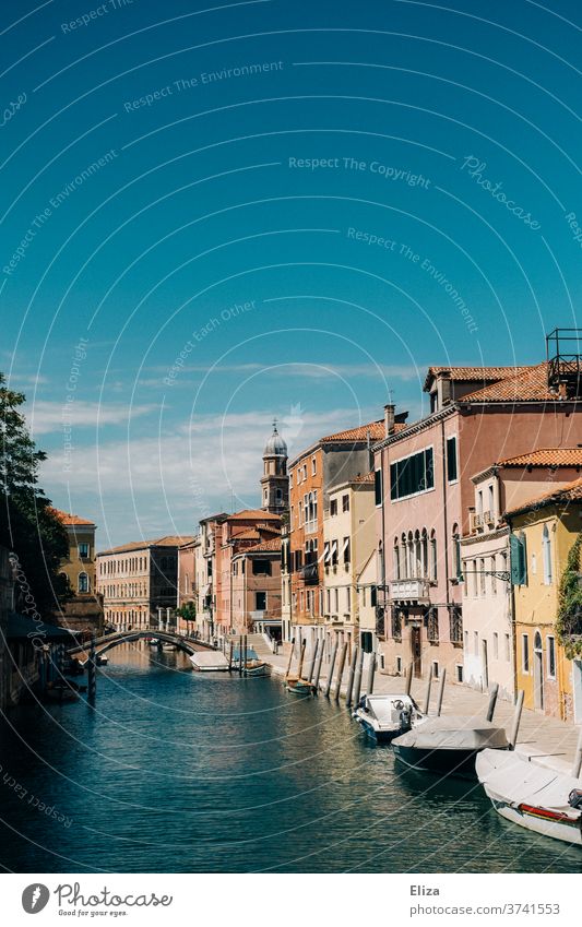 Canal with boats and old houses under blue sky and sunshine in Venice Channel Water Old town Blue sky Historic Italy Town Bridge Summer variegated