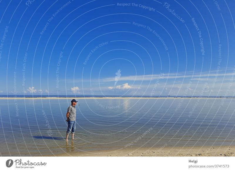 Bathing feet - Senior stands in the water on the North Sea beach in beautiful late summer weather Man Senior citizen Human being 60 years and older Adults