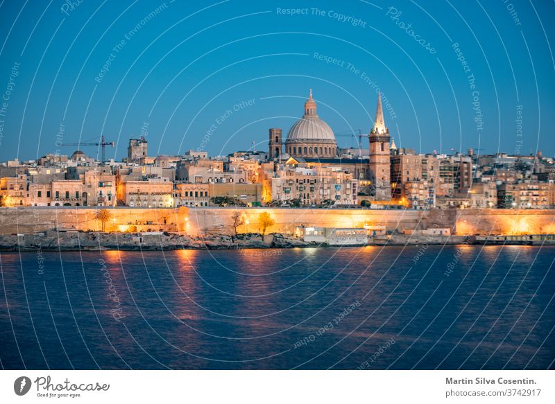 Panoramic view of Valletta Skyline at beautiful sunset from Sliema with churches of Our Lady of Mount Carmel and St. Paul's Anglican Pro-Cathedral, Valletta, Capital city of Malta