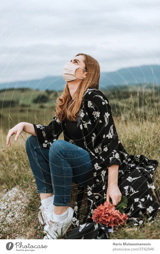 Young woman with mask looking at the sky, escape from city adult attractive beautiful beauty caucasian coronavirus covid-19 everyday life face mask fashion