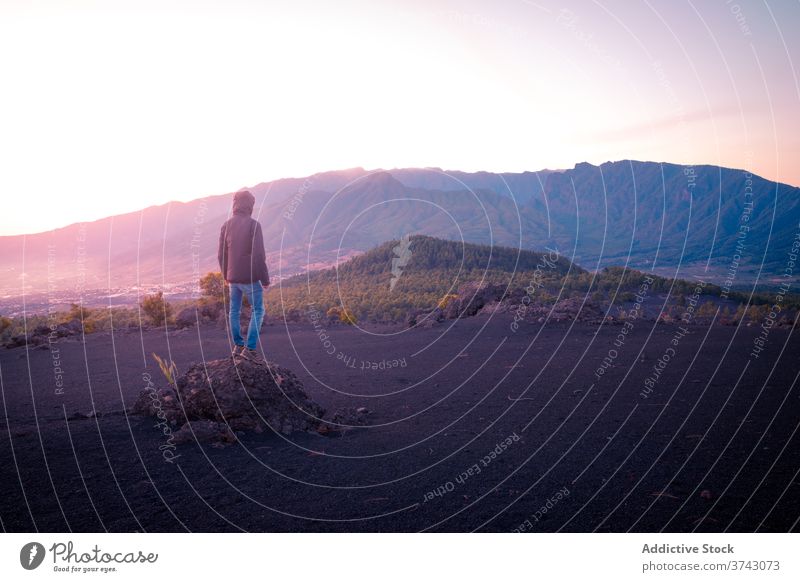 Lonely traveler in highland valley spectacular scenery mountain range admire lonely enjoy tourist landscape scenic adventure freedom sunset nature tourism sky