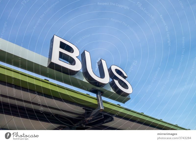 big white physical bus sign type all capital letters bus station transportation station bus stop company business logo exterior corporation office building