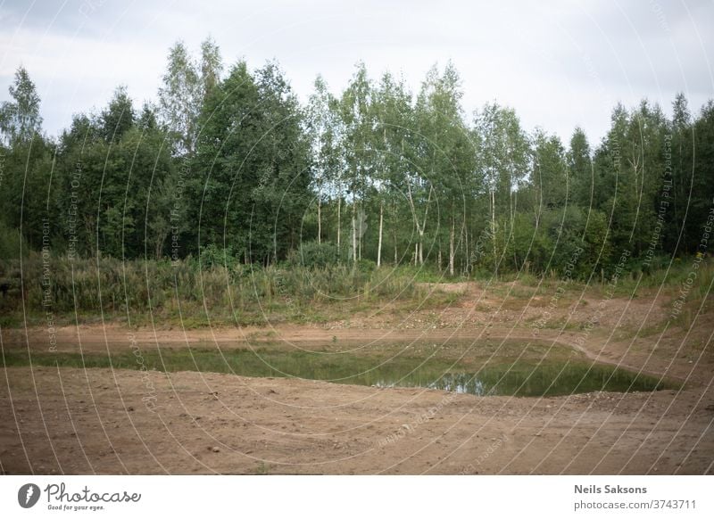 small pond in gravel mine near forest Gravel water Lake Reflection Nature Tree Exterior shot Deserted Colour photo Environment Landscape Calm Surface of water