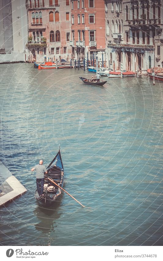 A gondolier in his gondola on the Grand Canal in Venice Gondolier Canal Grande Water Gondola (Boat) Italy City trip Tourist Attraction Channel traditionally